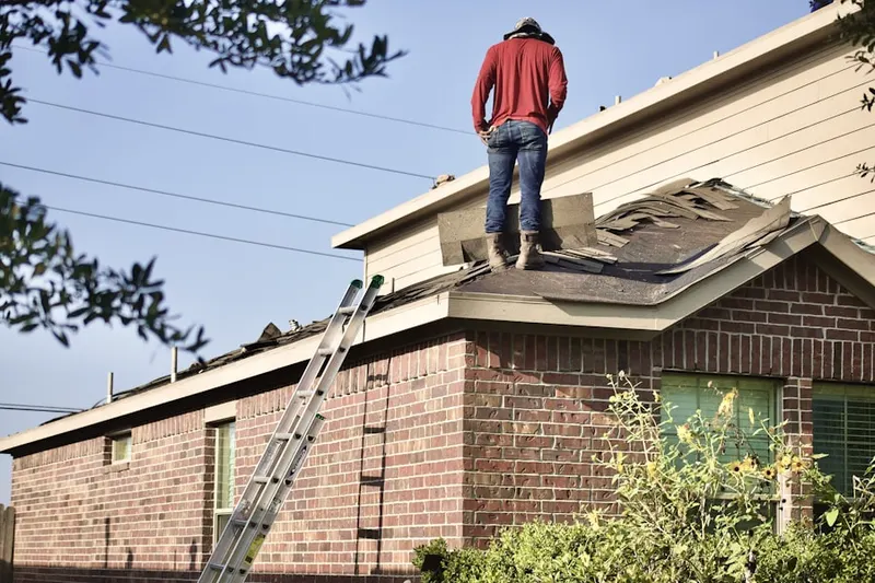 Professional roofer working on a residential roof in Mukwonago